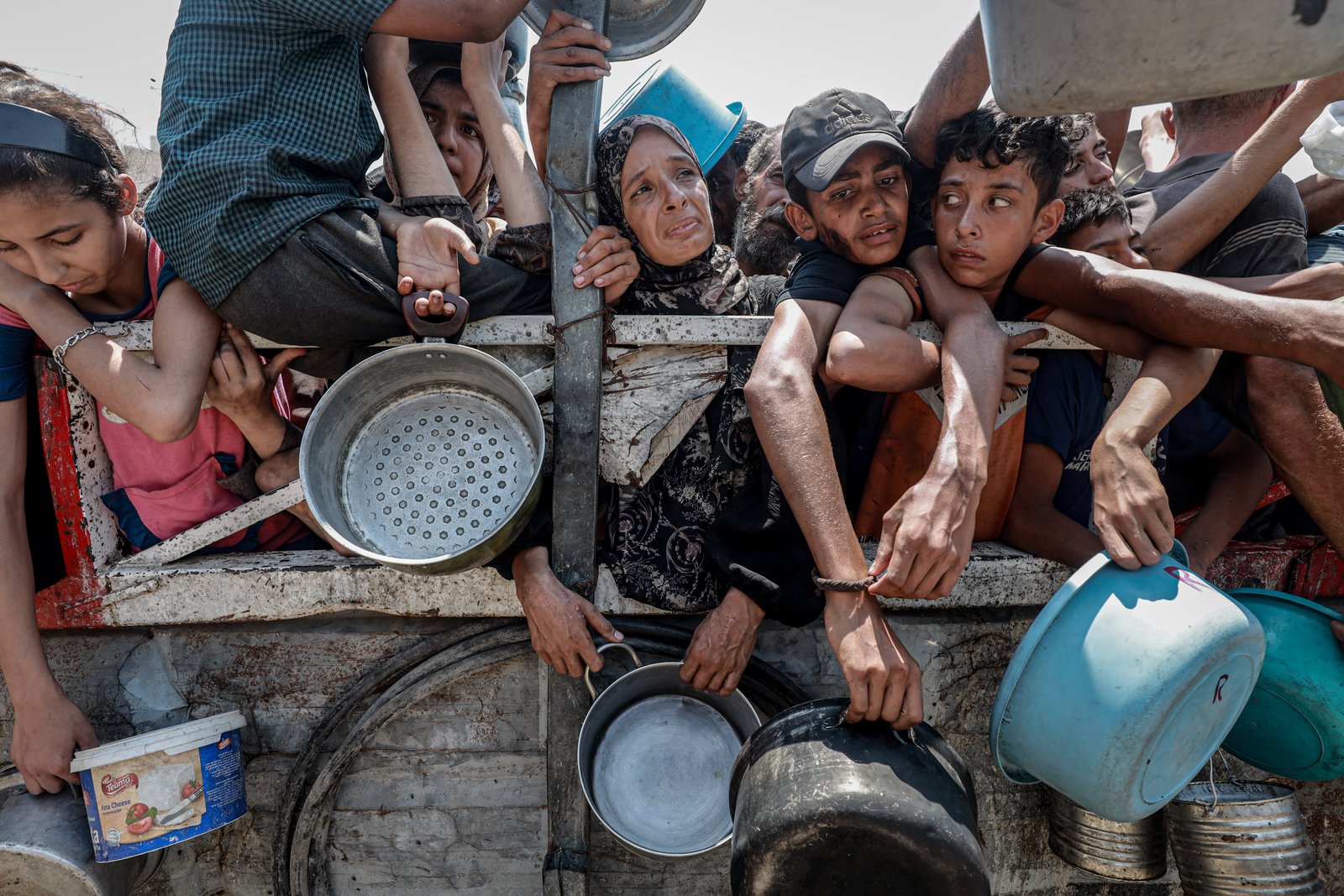 Palestinians wait in queue to get hot meals distributed by aid organizations in Gaza City, Gaza on July 26, 2025. (Photo by Khames Alrefi/Anadolu via Getty Images)
