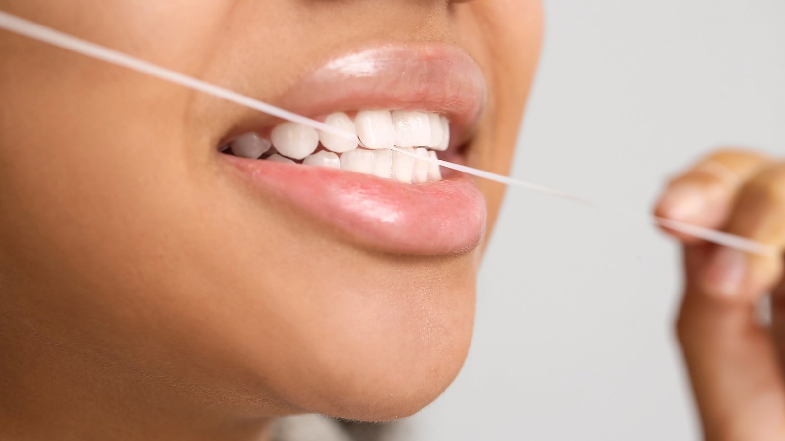 Close up of women flossing