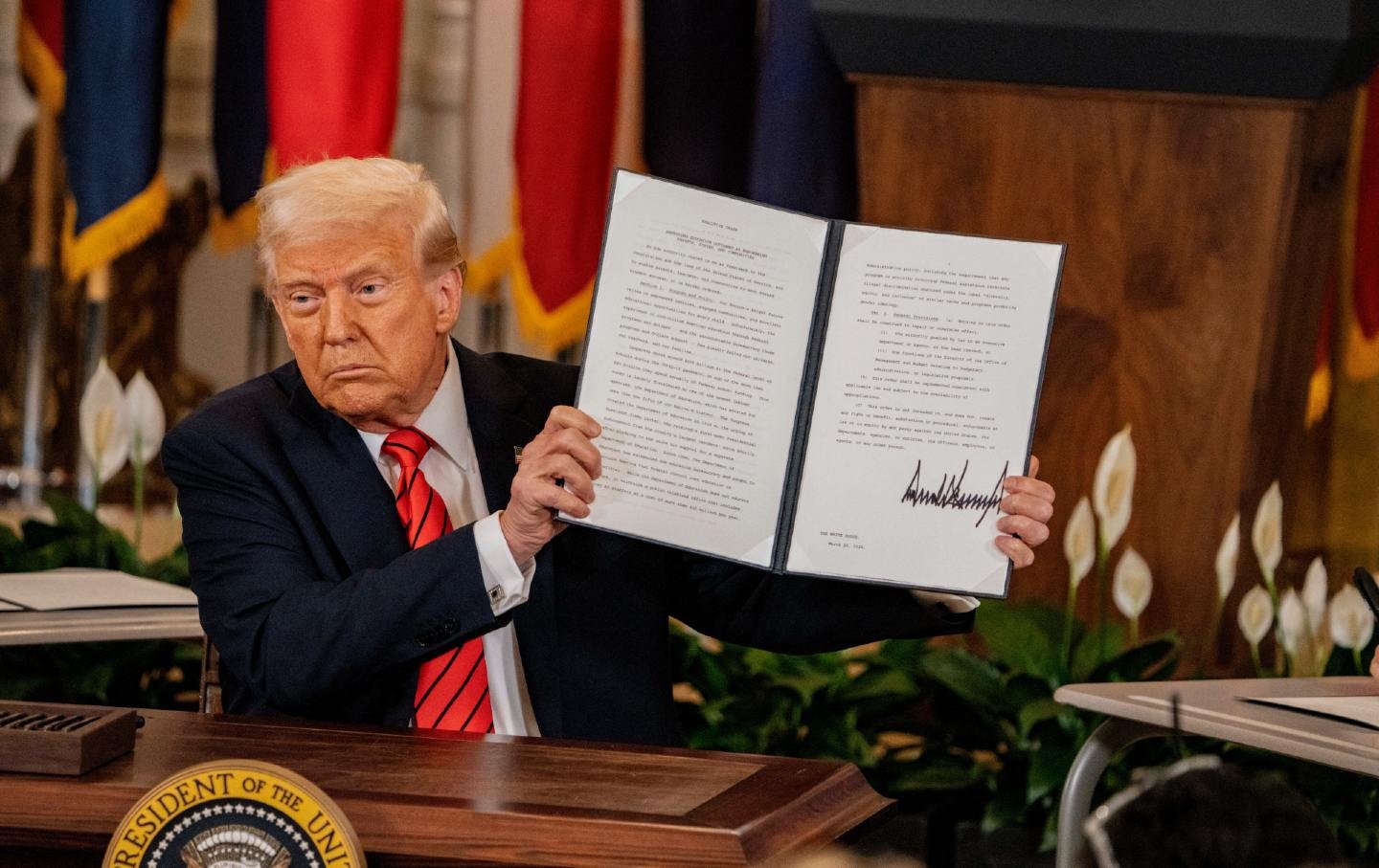Donald Trump signs an executive order to eliminate the Department of Education, in Washington, DC, on March 20, 2025.