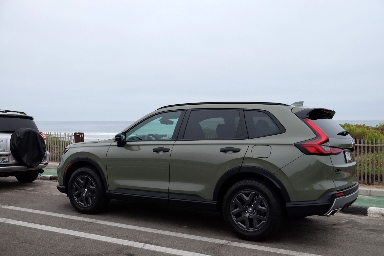 a honda cr v parked in front of the ocean