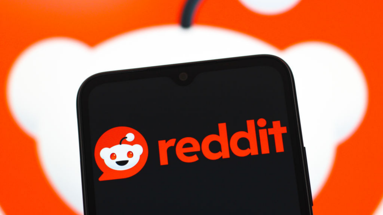 The Reddit logo is seen displayed on a smartphone screen.
