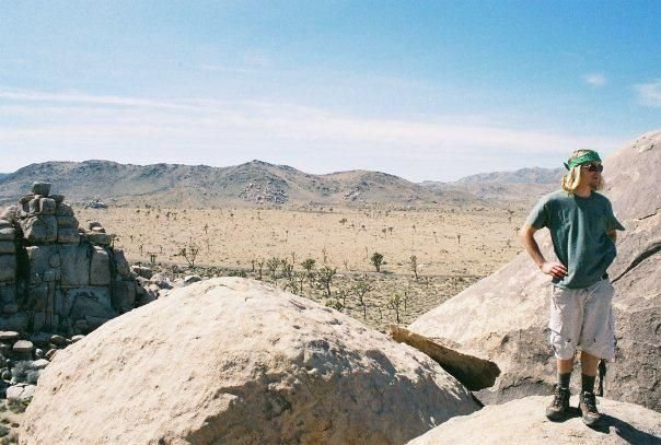 person standing on rocky terrain in a desert landscape