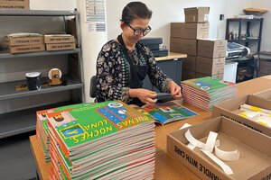 Kim Tan adds braille writing to children's books at the National Braille Press in Boston.