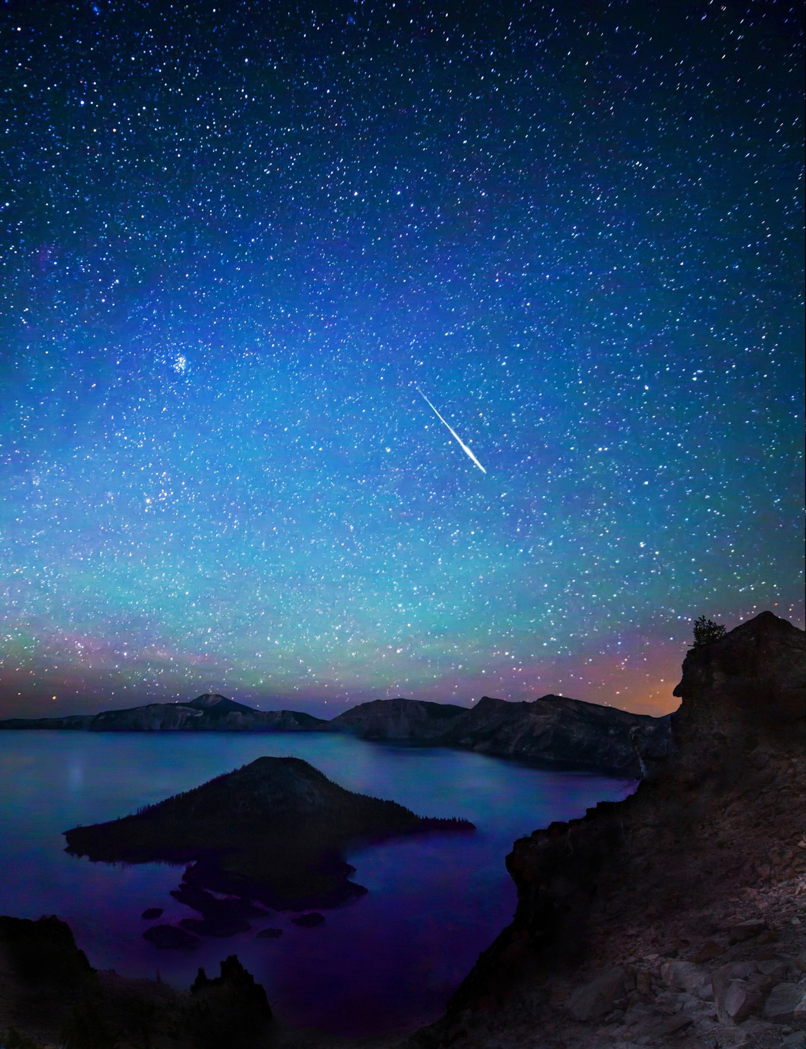 A bright Perseid meteor streaks through a star-filled sky above Wizard Island in Oregon's famed Crater Lake.