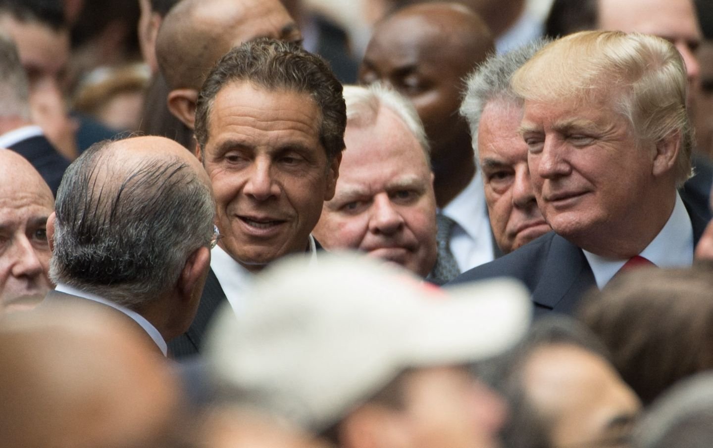 New York Governor Andrew Cuomo (C) speaks with former New York City Mayor Rudolph Giuliani (L) as Republican presidential candidate Donald Trump, right looks on during the 15th Anniversary of September 11 at the 9/11 Memorial and Museum, on September 11, 2016 in New York.