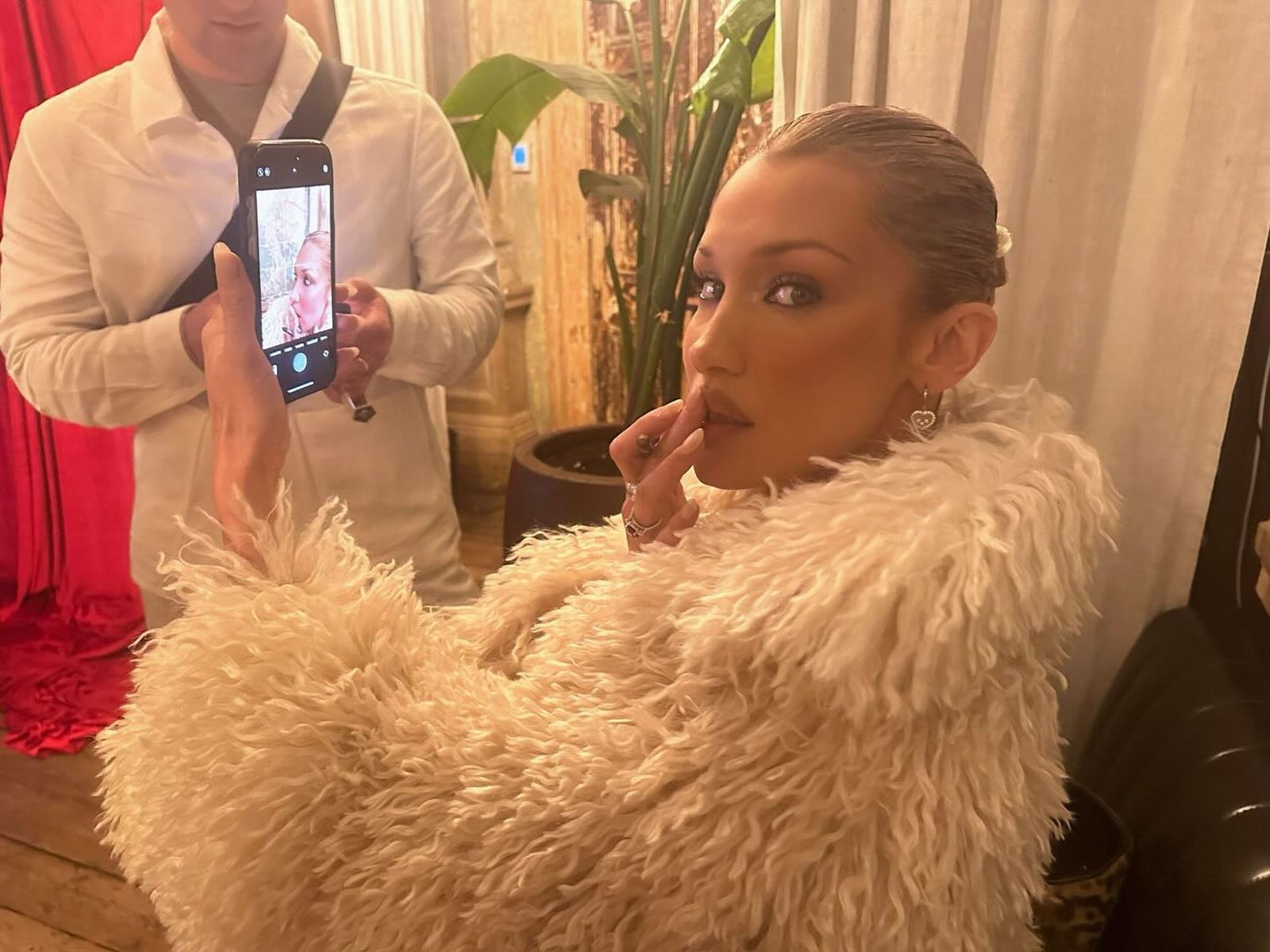 Bella Hadid in a white coat. 