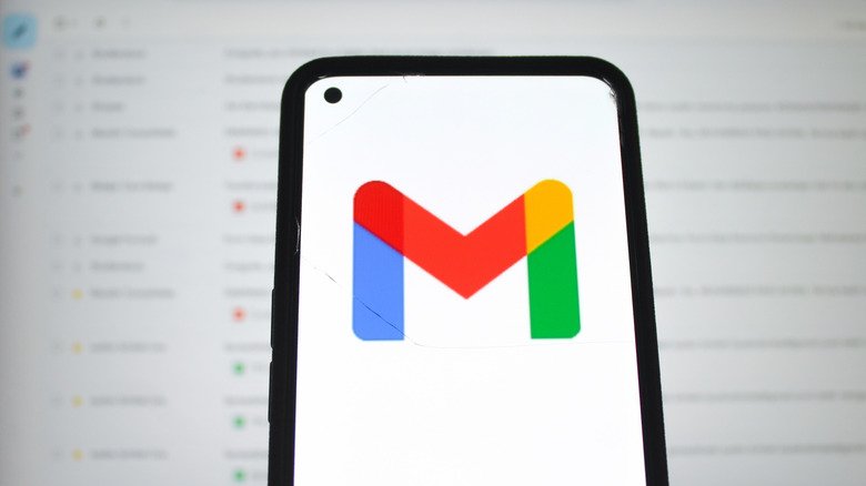 Gmail icon on smartphone. in front of blurred screen