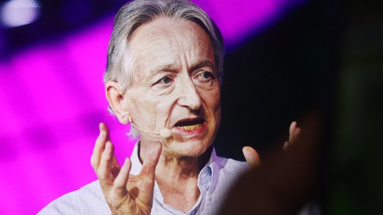 Geoffrey Hinton, the Godfather of AI, talking into a microphone on stage at a conference
