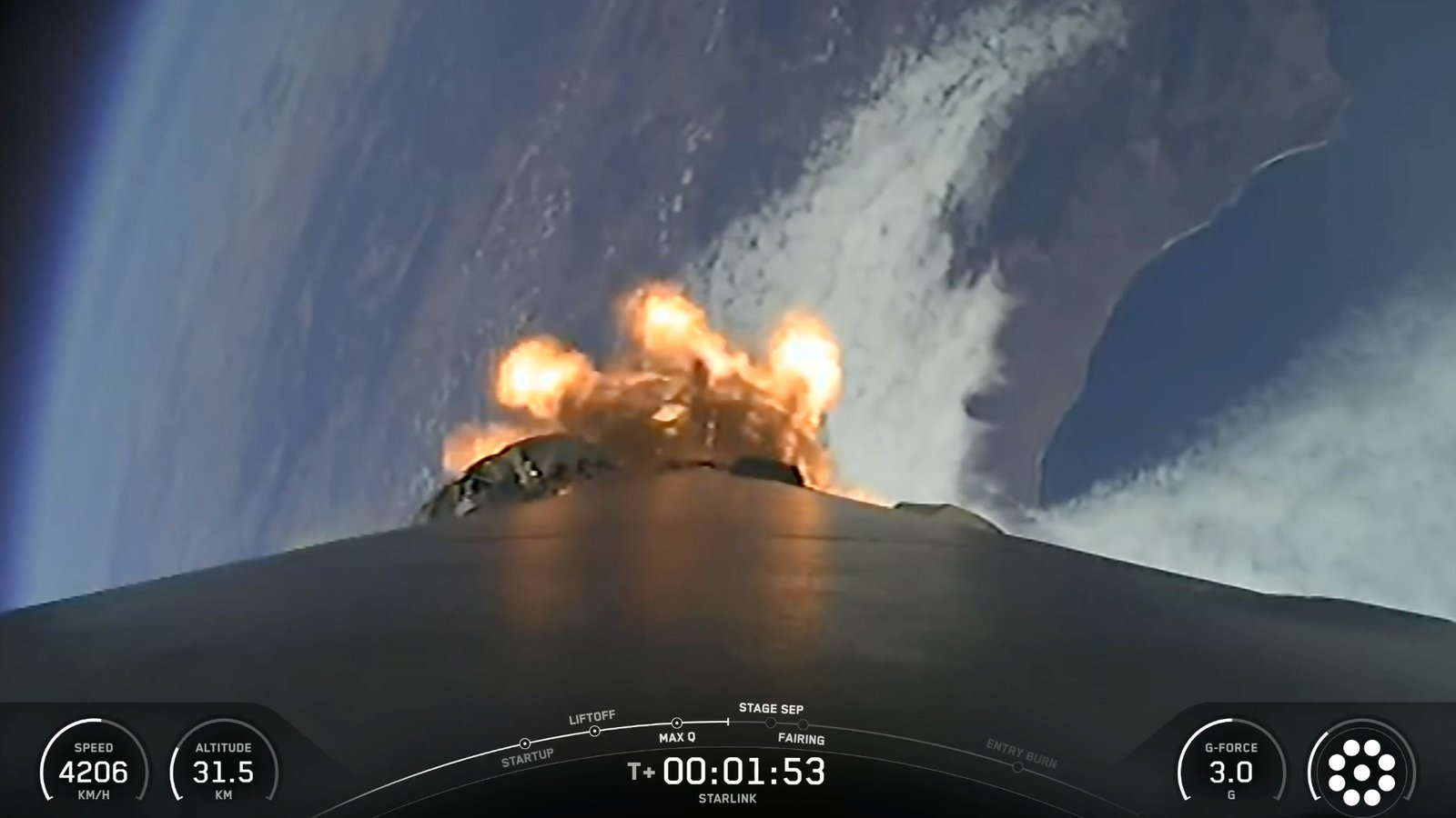 view from the top of a rocket looking down at a curve of coastline, with the blackness of space visible in the background