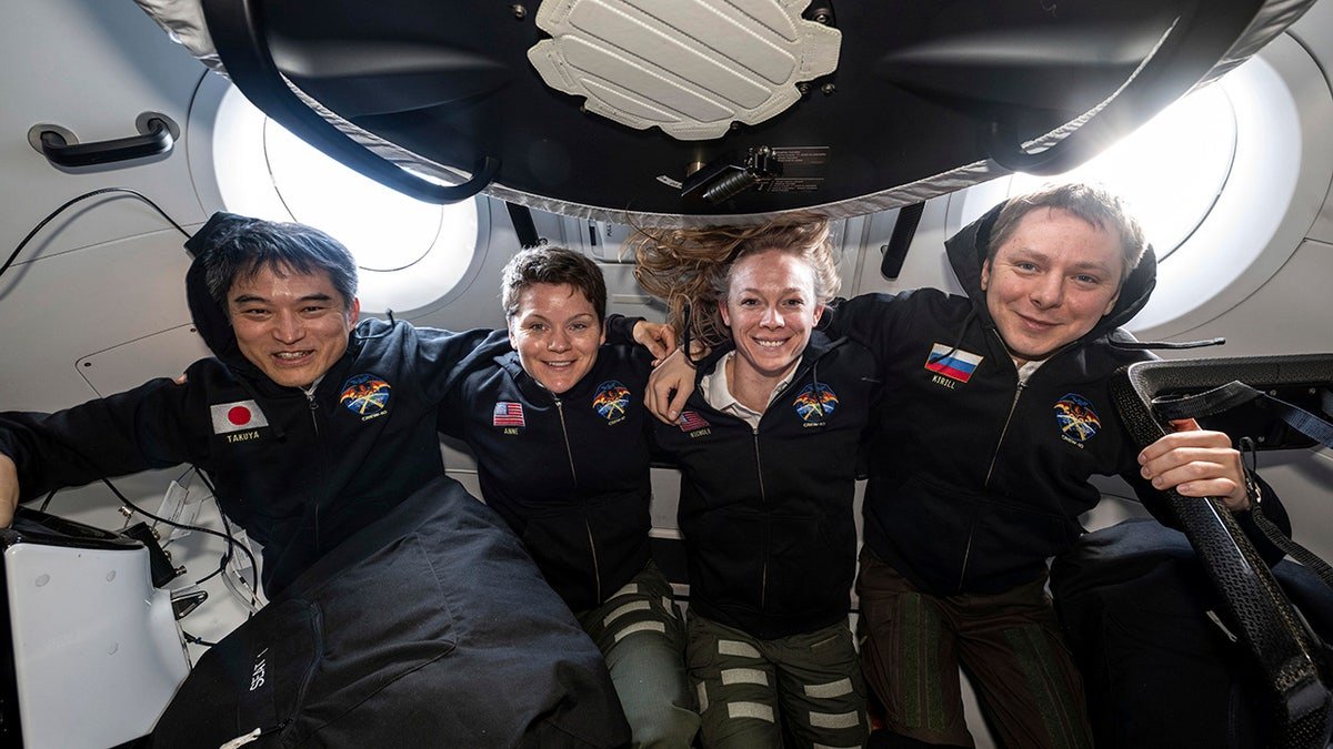 Crew members inside SpaceX capsule