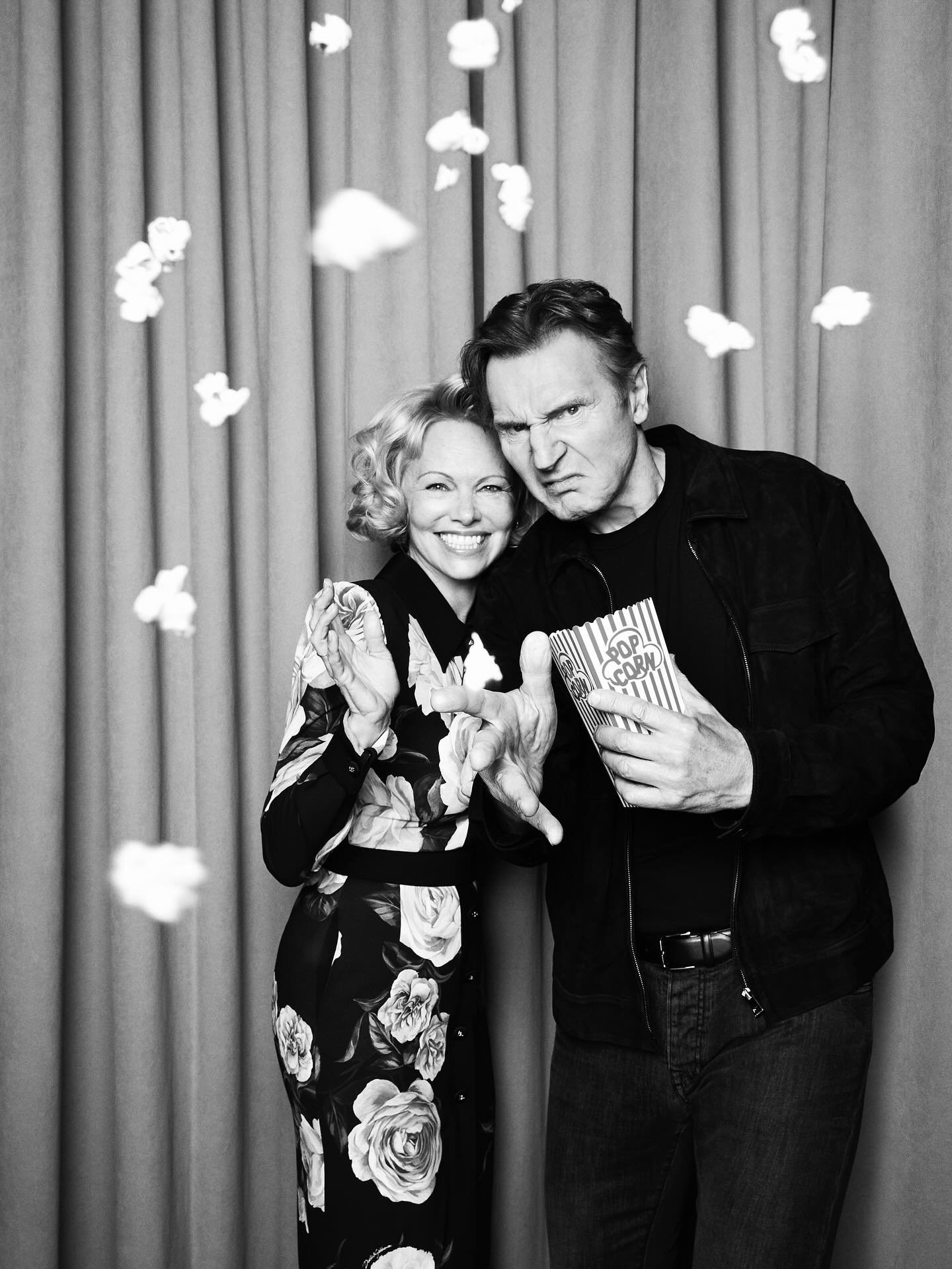 Pamela Anderson and Liam Neeson throwing popcorn