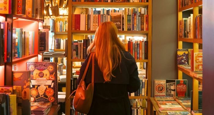 person perusing the shelves in a bookstore