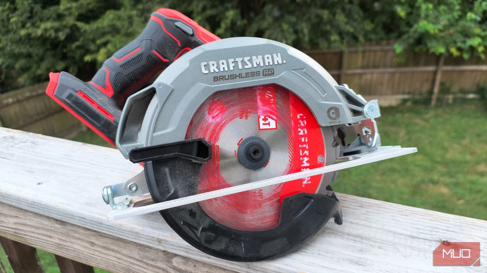A circular saw sitting on a wooden rail